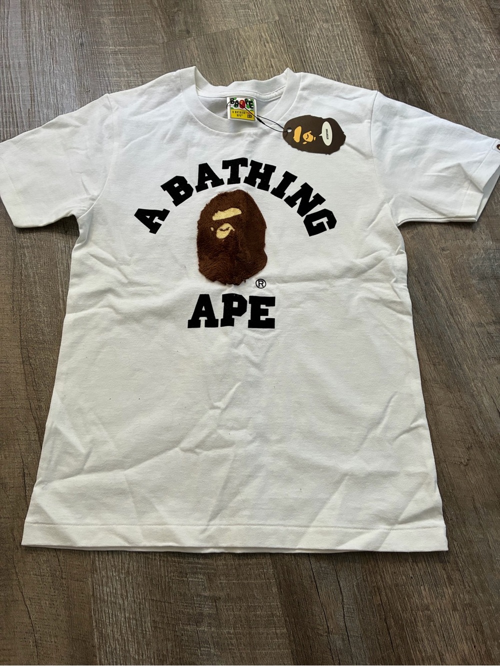 A Bathing Ape White Logo Graphic Tee with Brown Ape Emblem